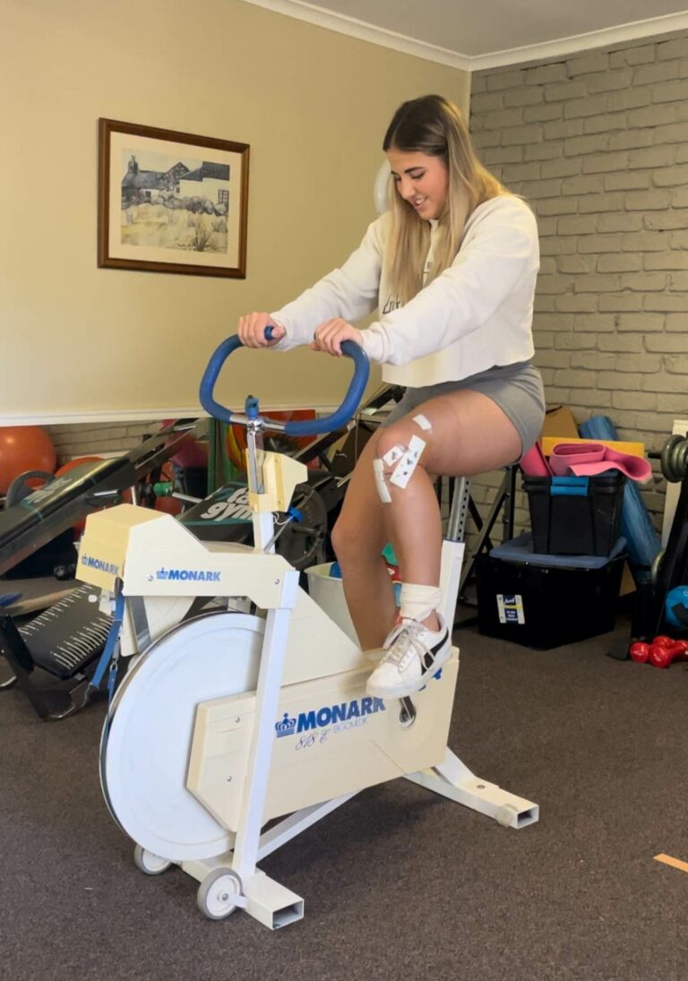 Photo of Girl Rehab on Bike - Physio Performance Institute - Simon Lloyd Physiotherapy Bathurst and Orange